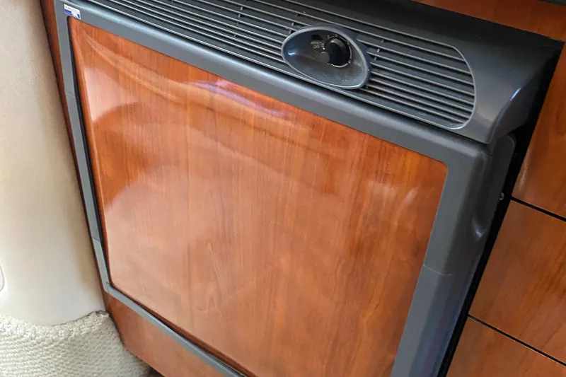 Slide: The Image of Wood-paneled refrigerator in 2007 Sea Ray 300 Sundancer yacht interior. - 26