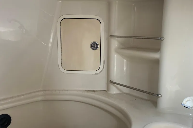 Slide: The Image of 2007 Sea Ray 300 Sundancer interior with storage compartment and shelves. - 27