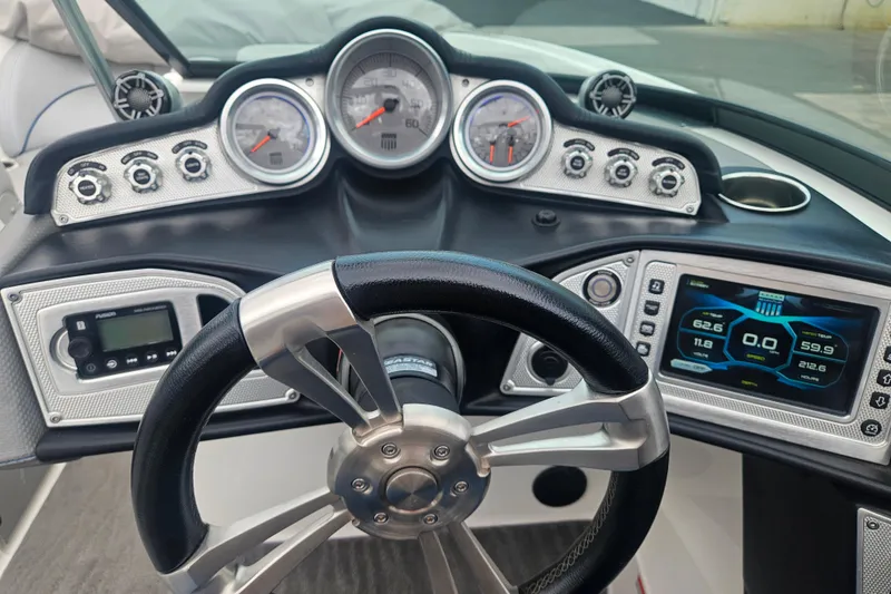 Slide: The Image of 2016 MasterCraft X23 dashboard with steering wheel, gauges, and digital display. - 11