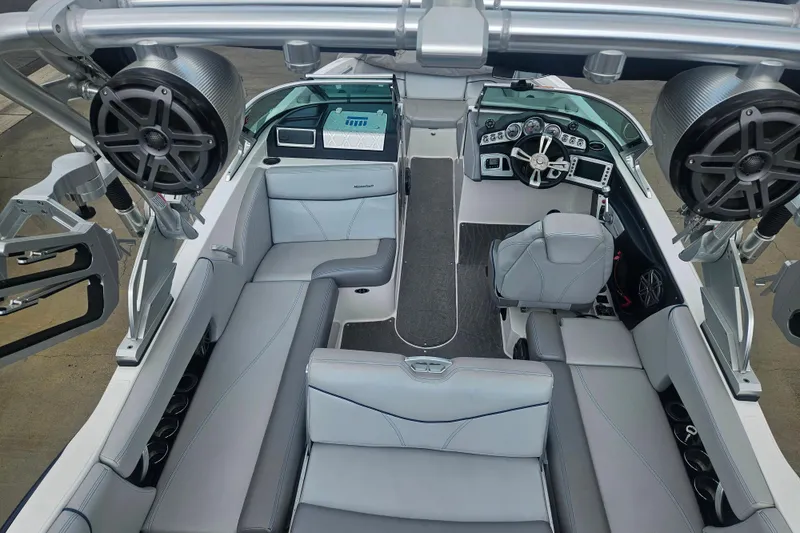 Slide: The Image of 2016 MasterCraft X23 boat interior with sleek seating and advanced dashboard controls. - 14