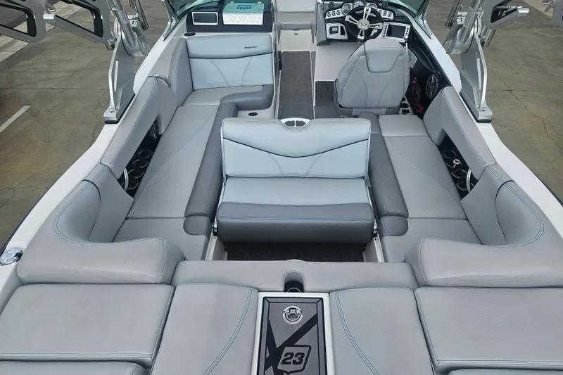 Slide: The Image of 2016 MasterCraft X23 boat interior with luxurious gray seating and modern dashboard. - 3
