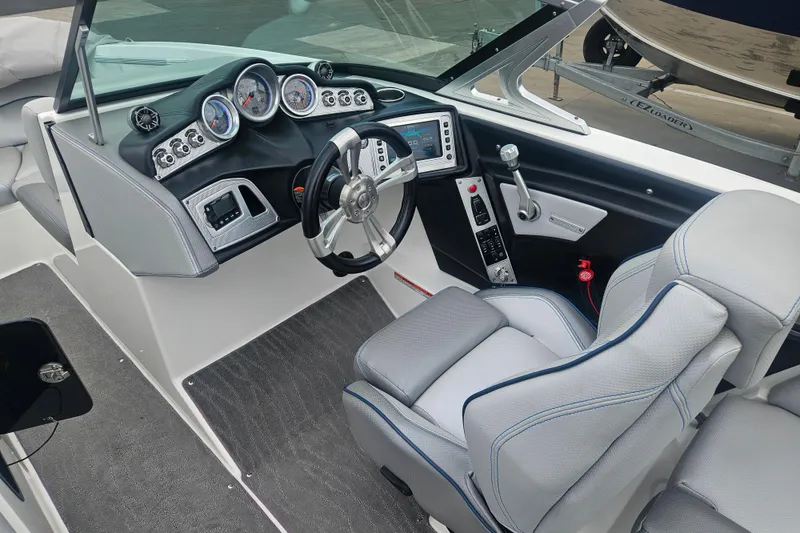 Slide: The Image of 2016 MasterCraft X23 boat interior with modern dashboard and steering wheel. - 7