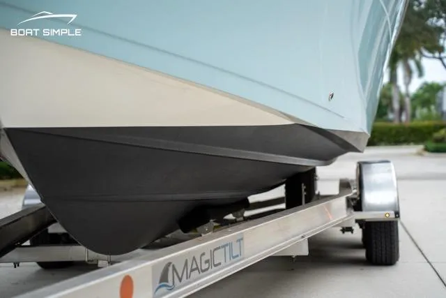 Slide: The Image of 2023 Cobia 240 Center Console boat on Magic Tilt trailer, close-up view. - 6