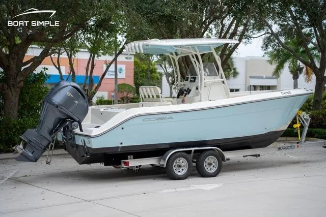Slide: The Image of 2023 Cobia 240 Center Console boat on trailer, parked outdoors. - 5