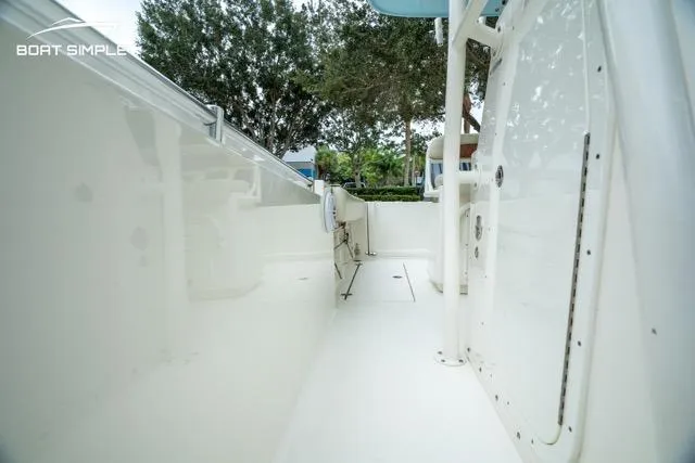 Slide: The Image of 2023 Cobia 240 Center Console boat interior with sleek white design and spacious layout. - 9