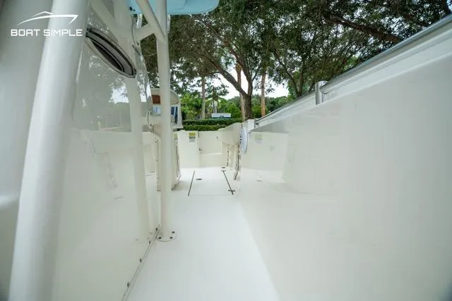 Slide: The Image of 2023 Cobia 240 Center Console boat interior with sleek white design and spacious layout. - 10