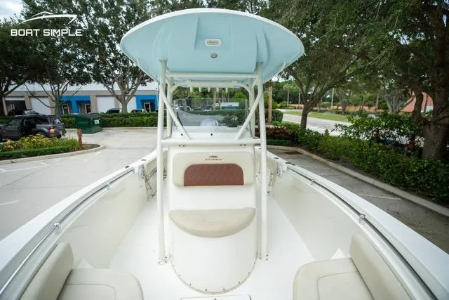 Slide: The Image of 2023 Cobia 240 Center Console boat, front view, parked outdoors, showcasing seating and console. - 19
