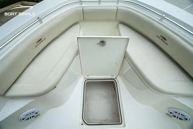 Slide: The Image of 2023 Cobia 240 Center Console boat interior with cushioned seating and storage compartment. - 16