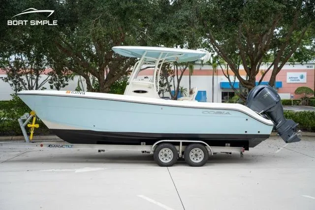 Slide: The Image of 2023 Cobia 240 Center Console boat on trailer, parked outdoors. - 0