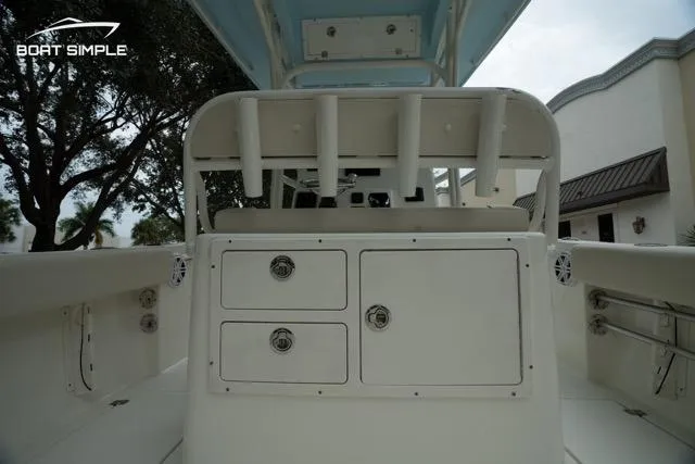 Slide: The Image of 2023 Cobia 240 Center Console boat interior with storage compartments and rod holders. - 17