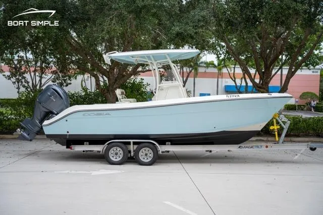 Slide: The Image of 2023 Cobia 240 Center Console boat on trailer, parked outdoors. - 3