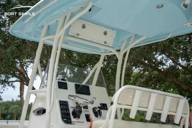 Slide: The Image of 2023 Cobia 240 Center Console boat interior with steering wheel and control panel. - 14
