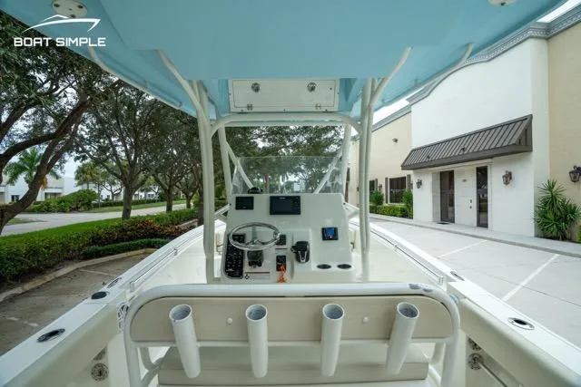 Slide: The Image of 2023 Cobia 240 Center Console boat interior with steering wheel and rod holders. - 22