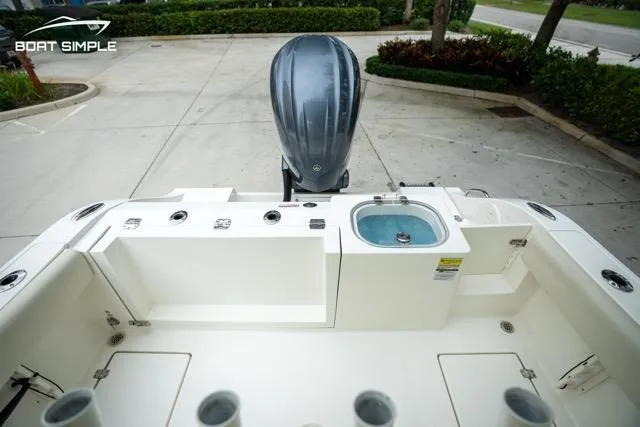 Slide: The Image of 2023 Cobia 240 Center Console boat with outboard motor and fishing amenities. - 23