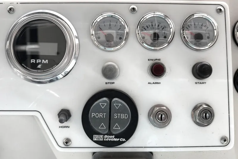 Slide: The Image of Control panel of a 1996 Riviera 39 Open Flybridge boat with gauges and switches. - 10