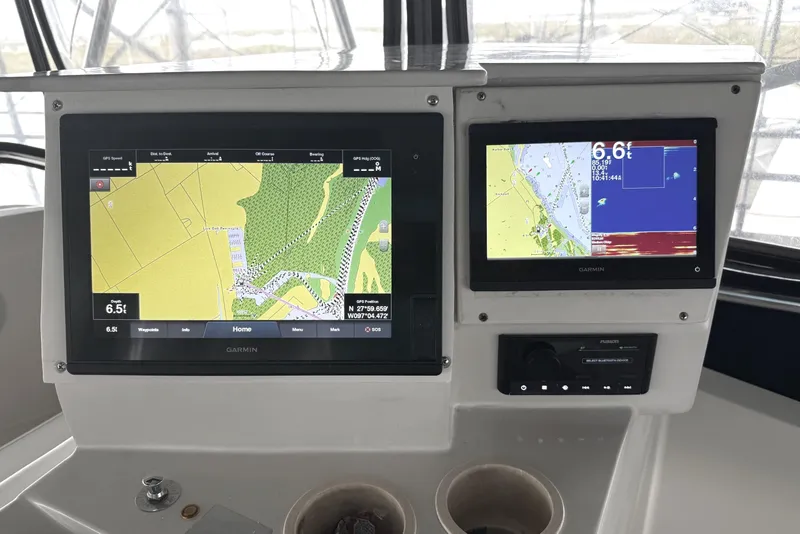 Slide: The Image of Garmin navigation screens on 1996 Riviera 39 Open Flybridge boat dashboard. - 12