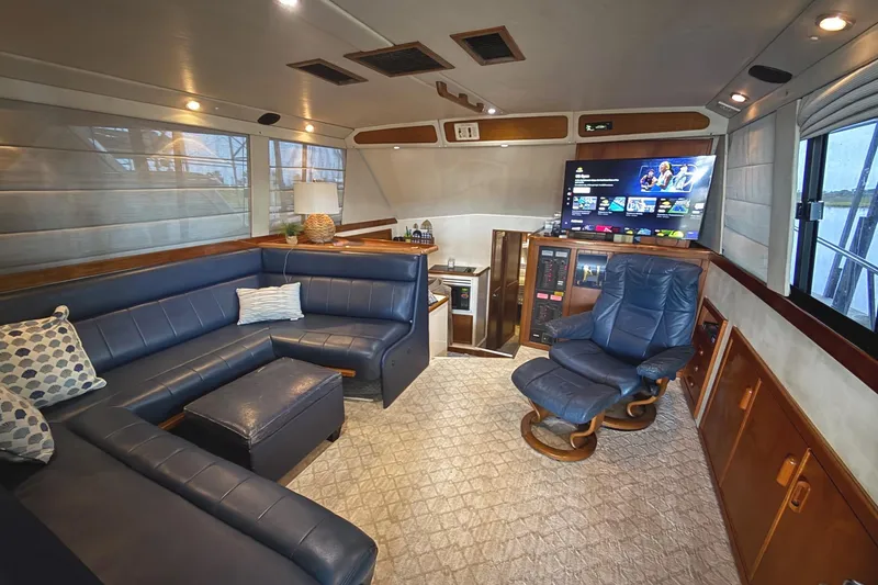Slide: The Image of Luxurious interior of 1996 Riviera 39 Open Flybridge with blue leather seating and modern amenities. - 17