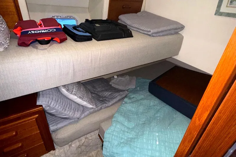Slide: The Image of Interior cabin of 1996 Riviera 39 Open Flybridge with bunk beds and storage. - 25