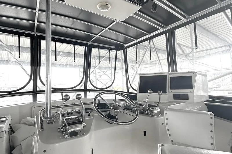 Slide: The Image of Interior view of 1996 Riviera 39 Open Flybridge helm with steering wheel and controls. - 3