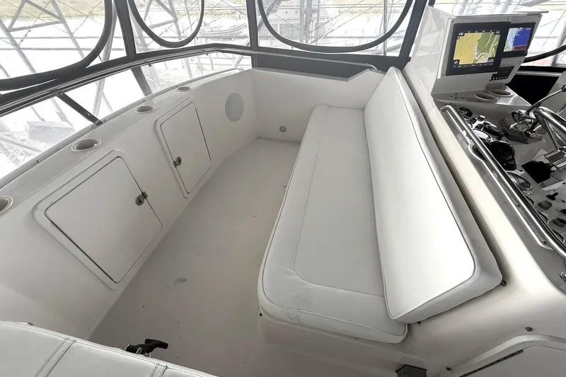 Slide: The Image of 1996 Riviera 39 Open Flybridge interior with white seating and navigation equipment. - 7
