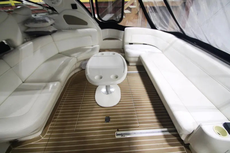 Slide: The Image of Luxurious interior of 1999 Sea Ray 460 Sundancer with white seating and wooden flooring. - 14