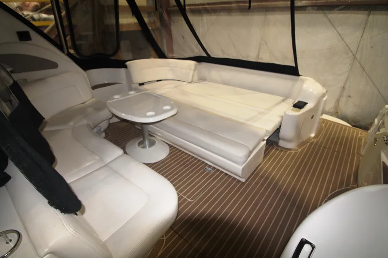 Slide: The Image of 1999 Sea Ray 460 Sundancer interior with white leather seating and small table. - 15