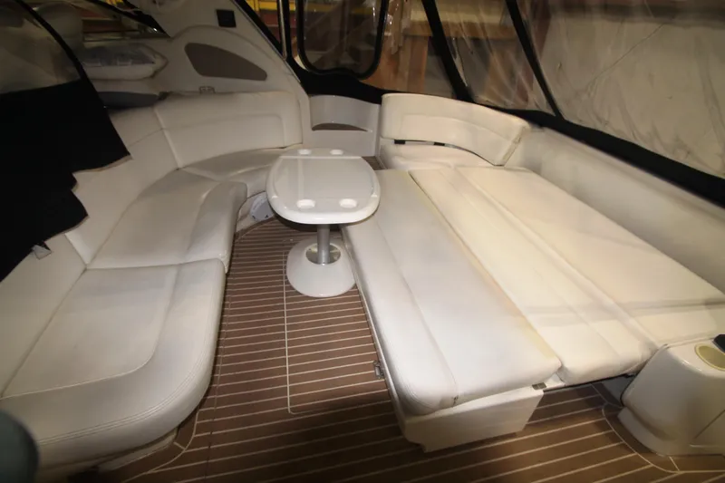 Slide: The Image of 1999 Sea Ray 460 Sundancer interior with white seating and wooden flooring. - 17