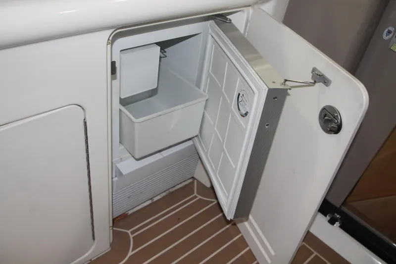 Slide: The Image of 1999 Sea Ray 460 Sundancer yacht interior with open mini fridge. - 18