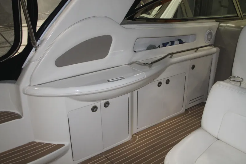 Slide: The Image of 1999 Sea Ray 460 Sundancer interior with sleek cabinetry and seating. - 19
