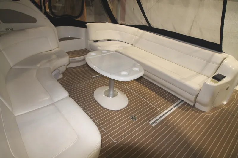 Slide: The Image of Luxurious interior of 1999 Sea Ray 460 Sundancer with white seating and table. - 4