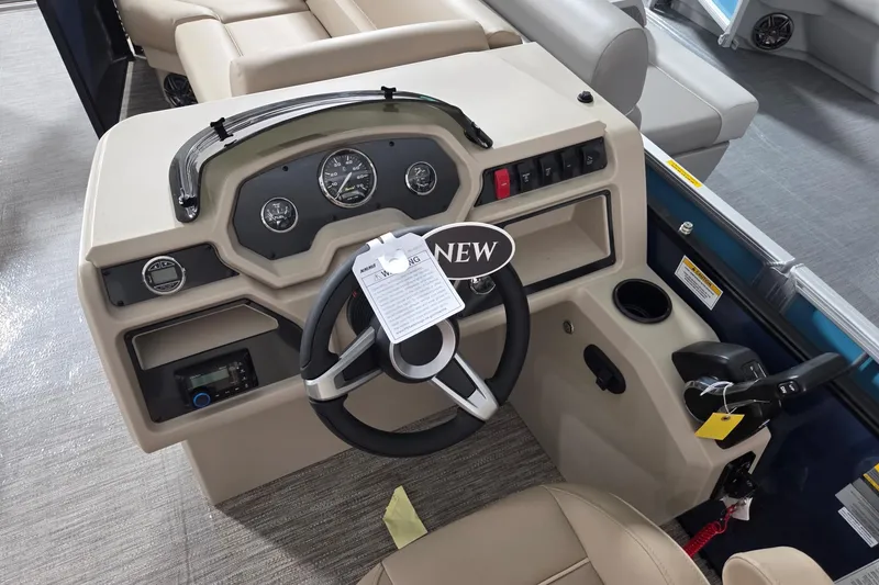 Slide: The Image of 2026 Godfrey Xperience 2286 SFLX boat dashboard with steering wheel and controls. - 3