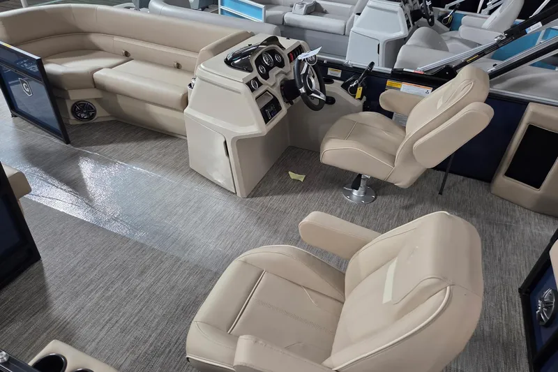 Slide: The Image of Interior of 2026 Godfrey Xperience 2286 SFLX boat with beige seating and steering console. - 4