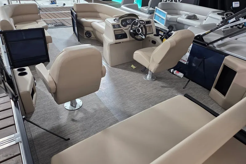 Slide: The Image of Interior of 2026 Godfrey Xperience 2286 SFLX boat with beige seating and modern dashboard. - 9