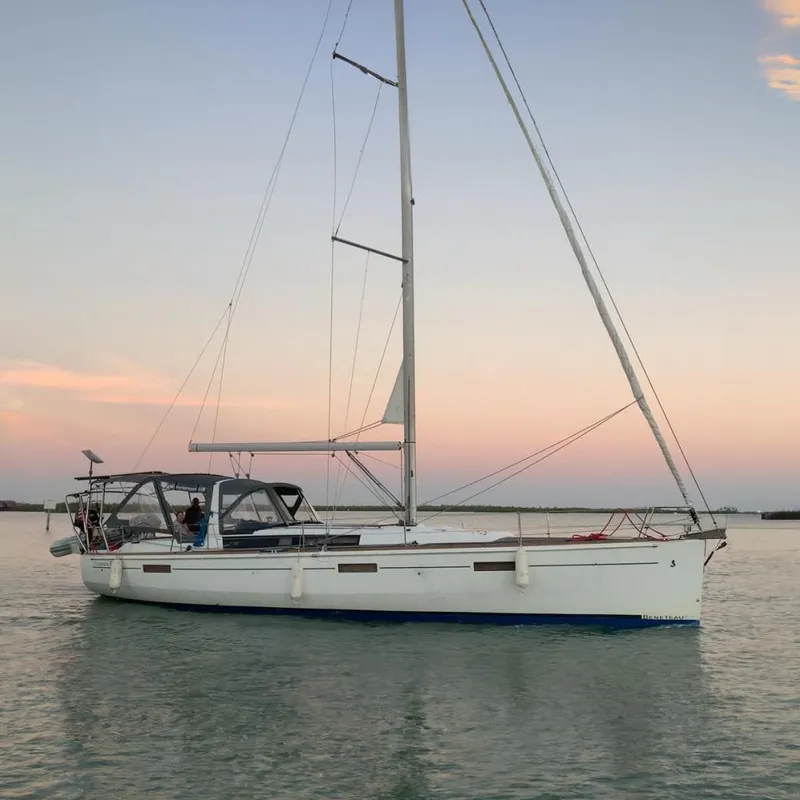 The Image of 2013 Beneteau Oceanis 45 sailboat on calm water at sunset. - 0