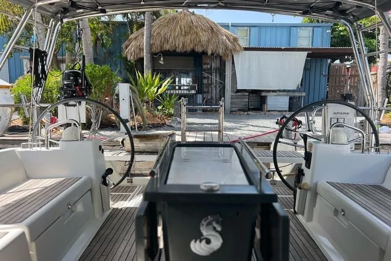 Slide: The Image of Cockpit view of 2013 Beneteau Oceanis 45 yacht docked near tropical hut. - 11