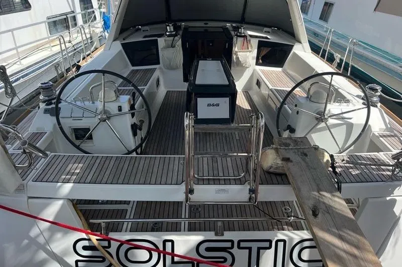 Slide: The Image of 2013 Beneteau Oceanis 45 yacht cockpit with dual steering wheels and teak decking. - 12