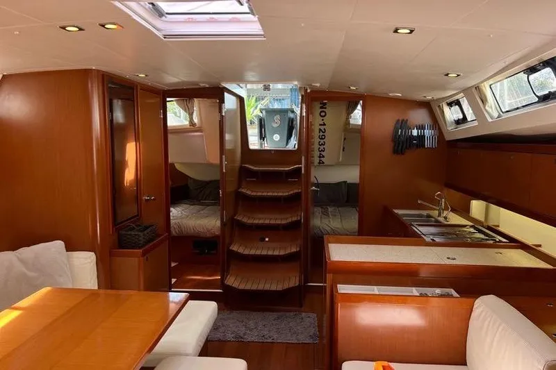 Slide: The Image of Interior of 2013 Beneteau Oceanis 45 yacht, featuring wood finish and modern amenities. - 14