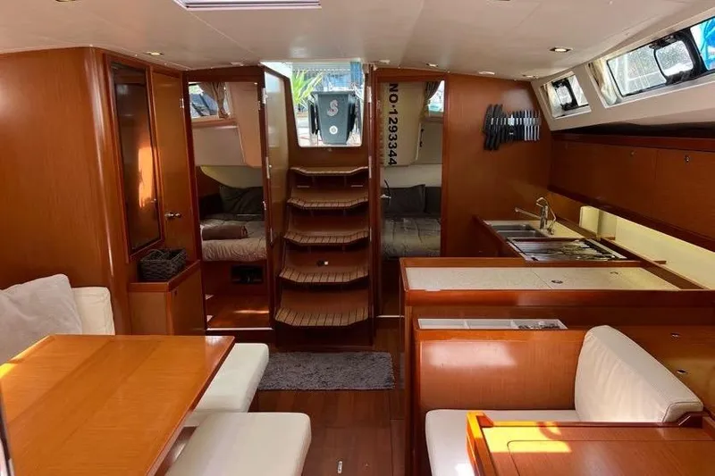 Slide: The Image of Interior of 2013 Beneteau Oceanis 45 yacht with wood finish and modern amenities. - 15