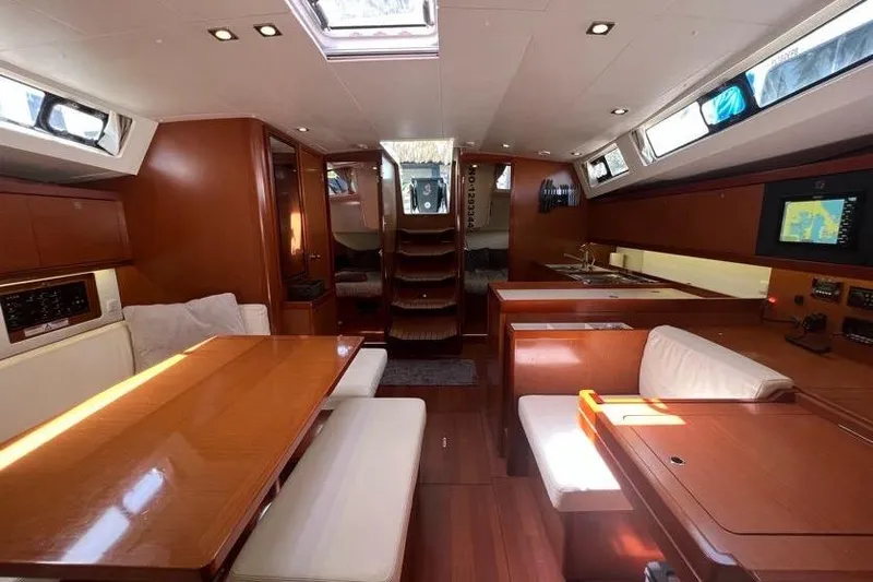 Slide: The Image of Interior of 2013 Beneteau Oceanis 45 yacht with wood finish and modern amenities. - 16