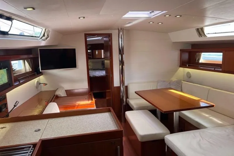 Slide: The Image of Interior of 2013 Beneteau Oceanis 45 yacht with modern furnishings and ample seating. - 23