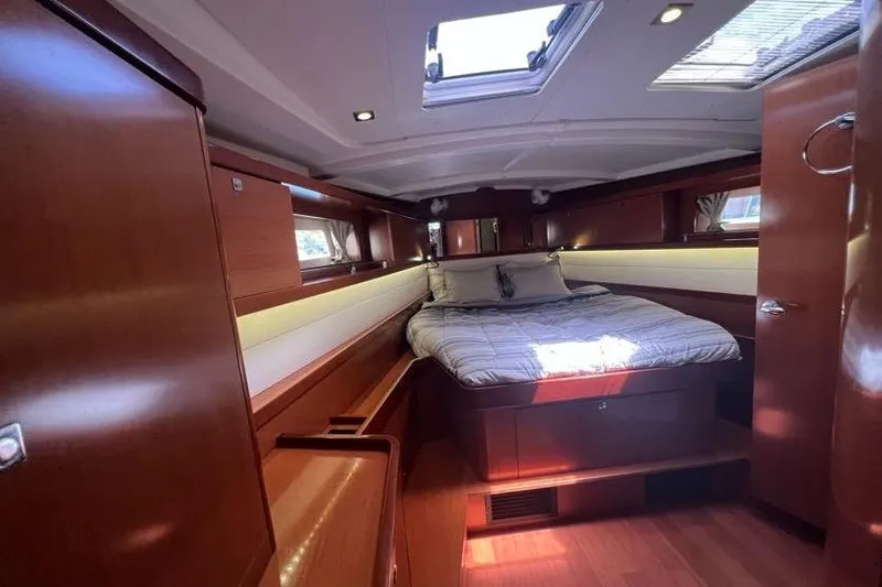 Slide: The Image of Luxurious interior cabin of 2013 Beneteau Oceanis 45 yacht with cozy bed and wooden finish. - 25
