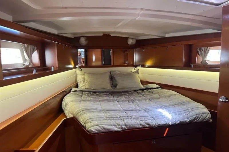 Slide: The Image of Luxurious cabin interior of 2013 Beneteau Oceanis 45 yacht with cozy bed and wooden finish. - 26