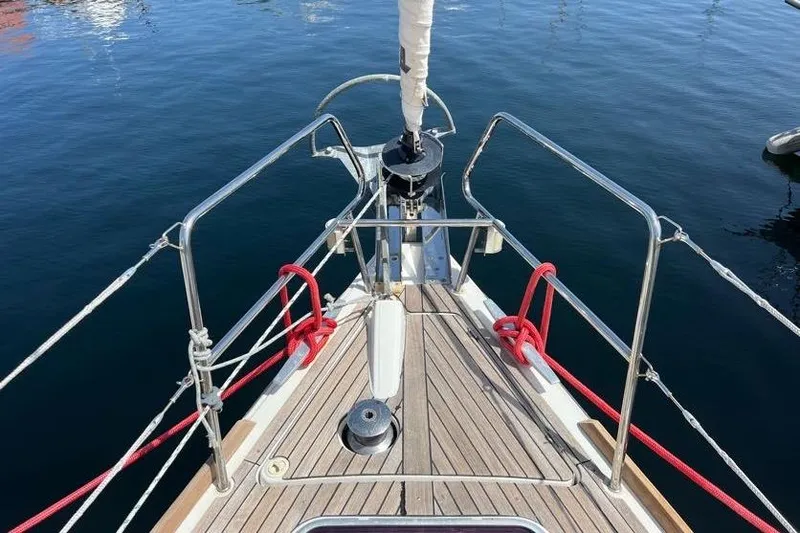 Slide: The Image of Bow of 2013 Beneteau Oceanis 45 sailboat with teak deck and red ropes. - 3