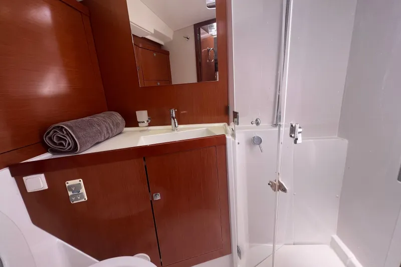 Slide: The Image of Bathroom interior of 2013 Beneteau Oceanis 45 yacht with wooden cabinetry and shower. - 30