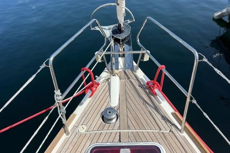 Slide: The Image of Bow of 2013 Beneteau Oceanis 45 sailboat with teak deck and red ropes. - 4