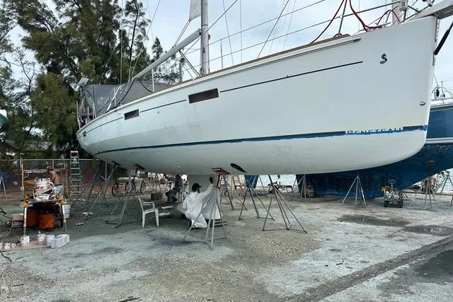 Slide: The Image of 2013 Beneteau Oceanis 45 sailboat on stands, undergoing maintenance in a boatyard. - 40