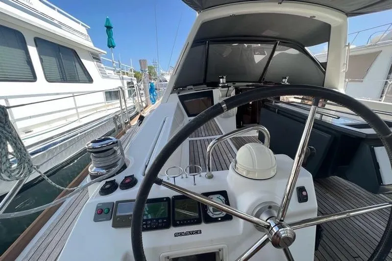 Slide: The Image of 2013 Beneteau Oceanis 45 yacht cockpit with steering wheel and navigation instruments. - 5