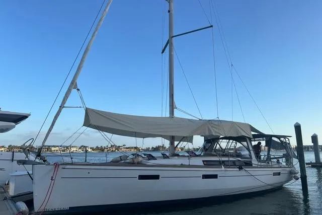 Slide: The Image of 2013 Beneteau Oceanis 45 sailboat docked at marina under clear blue sky. - 7