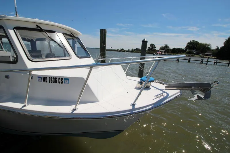 Slide: The Image of 2019 Judge 27 Chesapeake boat docked on a sunny day, featuring a sleek white design. - 10