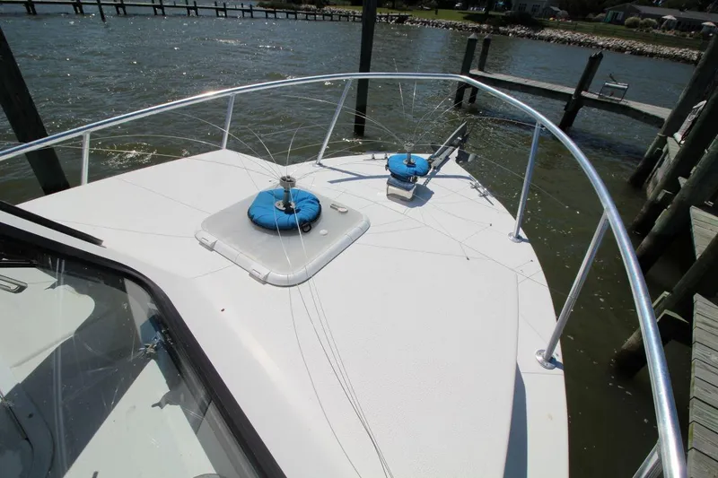 Slide: The Image of 2019 Judge 27 Chesapeake boat deck with railing, docked by the water. - 11